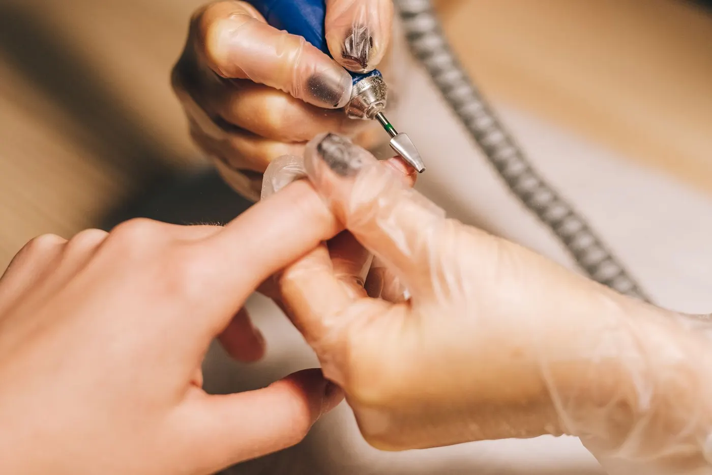 Gel polish being removed with an e-file in a salon